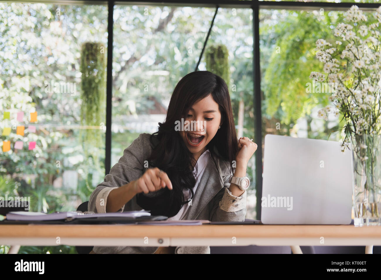 young start up woman feeling happy at office. freelance female entrepreneur glad with successful project. businesswoman working at workplace. success, Stock Photo