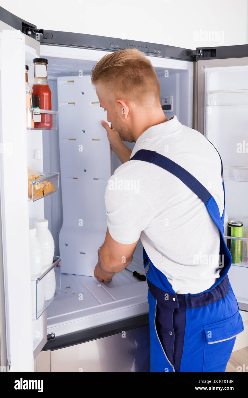 Repairman Fixing Refrigerator Stock Photo Alamy