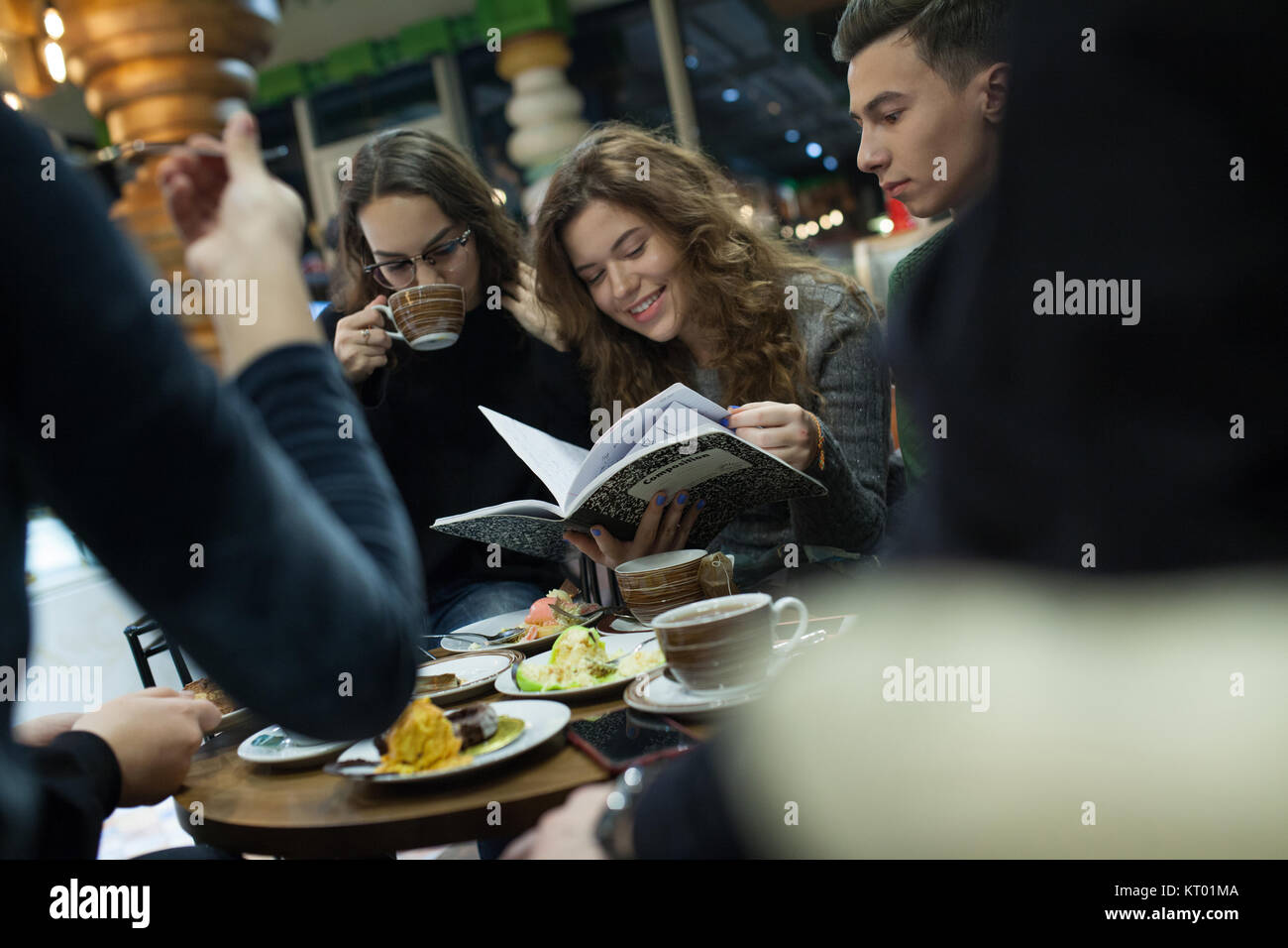 Group of teenagers doing homework in cafe Stock Photo Alamy