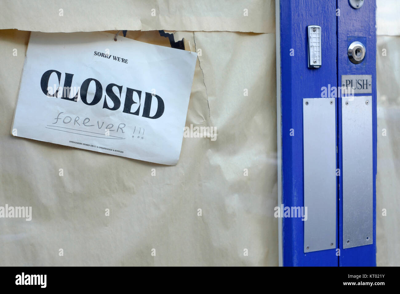 a closed sign with the word forever hand written underneath hangs in the window of an out of business shop england uk Stock Photo