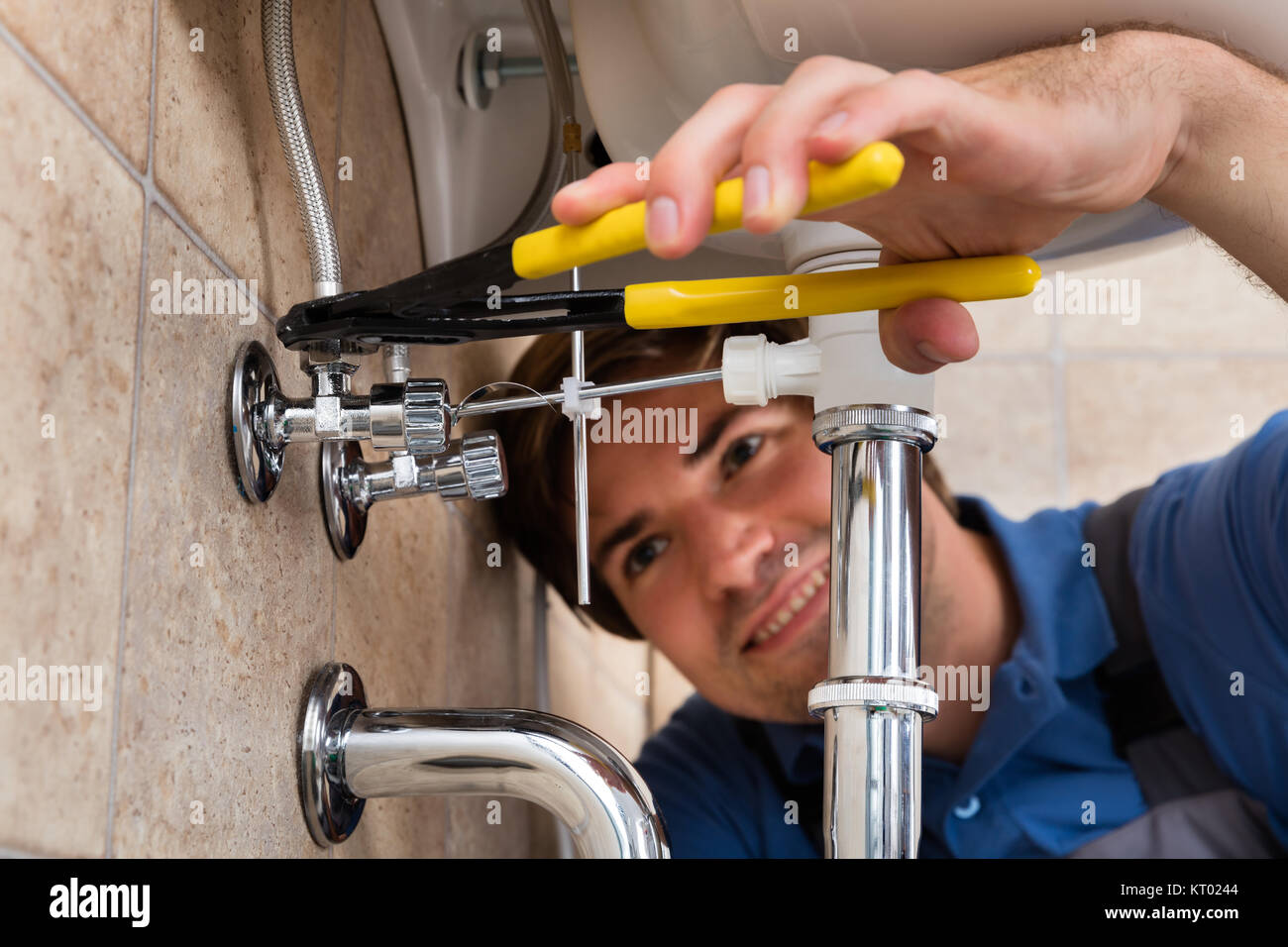 Male Plumber Installing Kitchen Sink Stock Photo Alamy