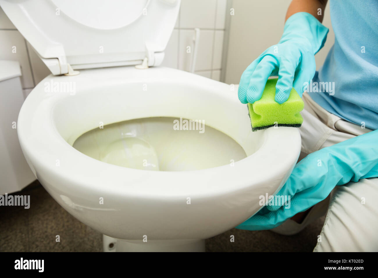 Close-up Of Person Cleaning Toilet Stock Photo