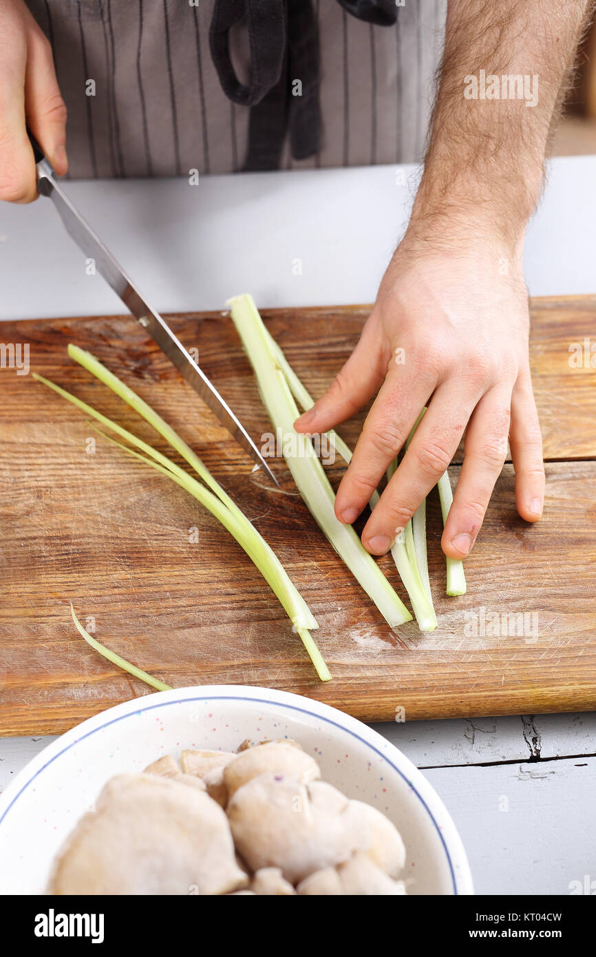 cutting vegetables. slicing knife vegetables. cook chopped vegetables on a chopping board. Stock Photo