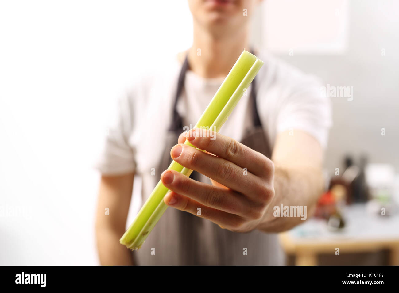 celery in the kitchen. celery cook holds in his hand a vegetable. Stock Photo