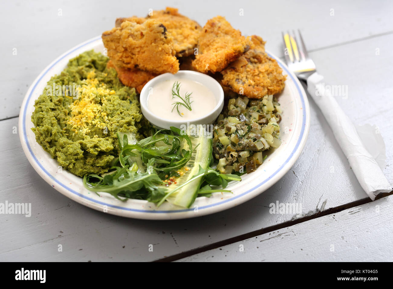 a dish of oyster mushrooms. vegan dish. oyster topped with bread crumbs mashed green peas Stock Photo