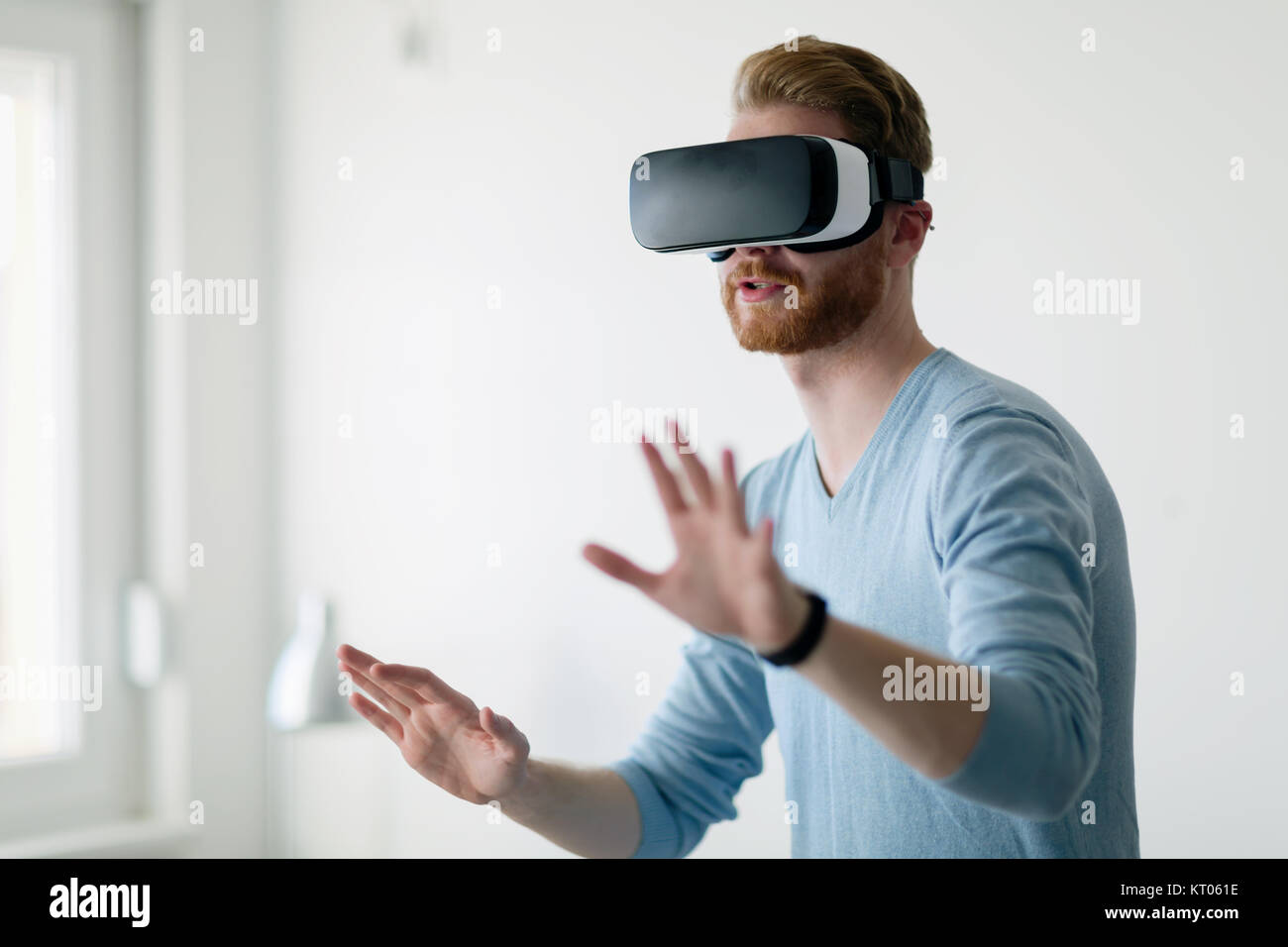 Man wearing virtual reality headset at home Stock Photo - Alamy