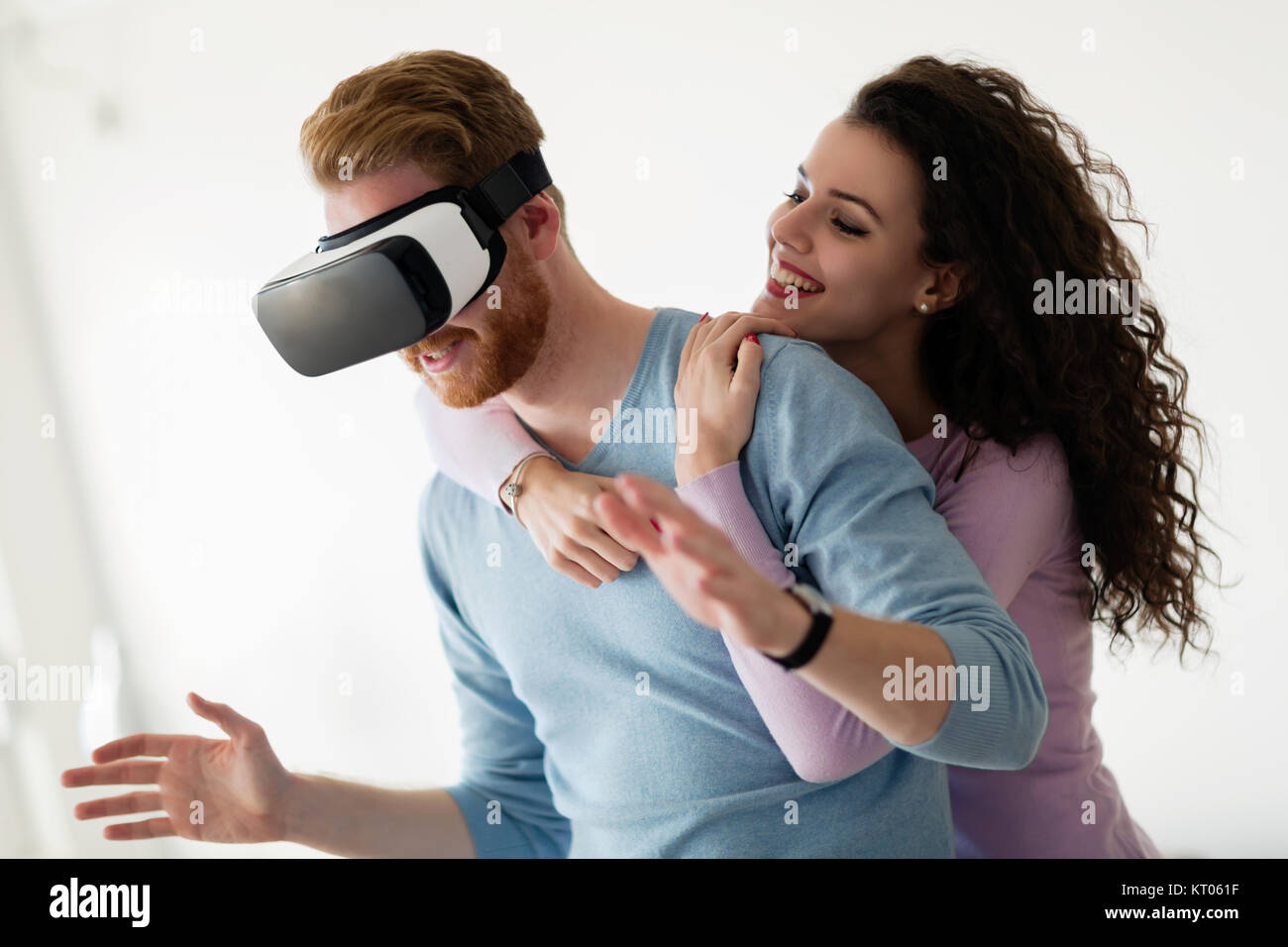 Attractive young couple trying virtual reality headset Stock Photo - Alamy