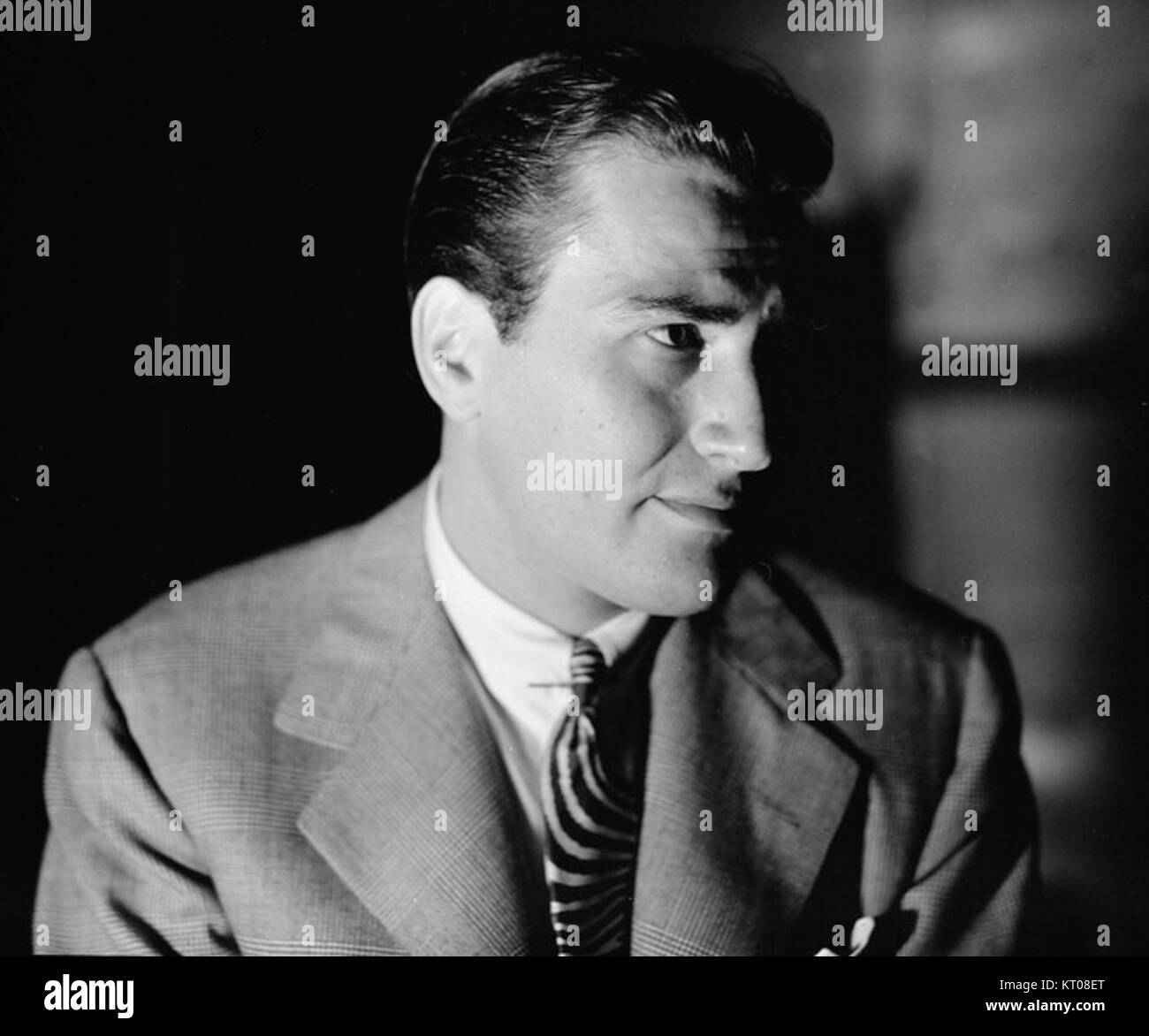 This image shows Artie Shaw, a renowned American clarinetist and bandleader, in a cropped photograph. Known for his contributions to jazz and big band music, Shaw was influential in the music scene during the 1930s and 1940s. Stock Photo
