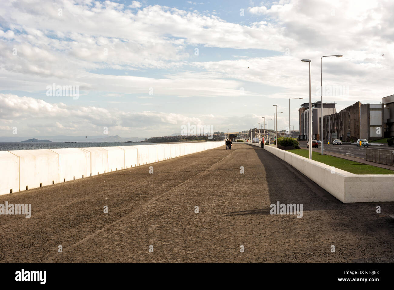 Sea front promenade in the town of Kirkcaldy, Scotland, people walking at a distance Stock Photo