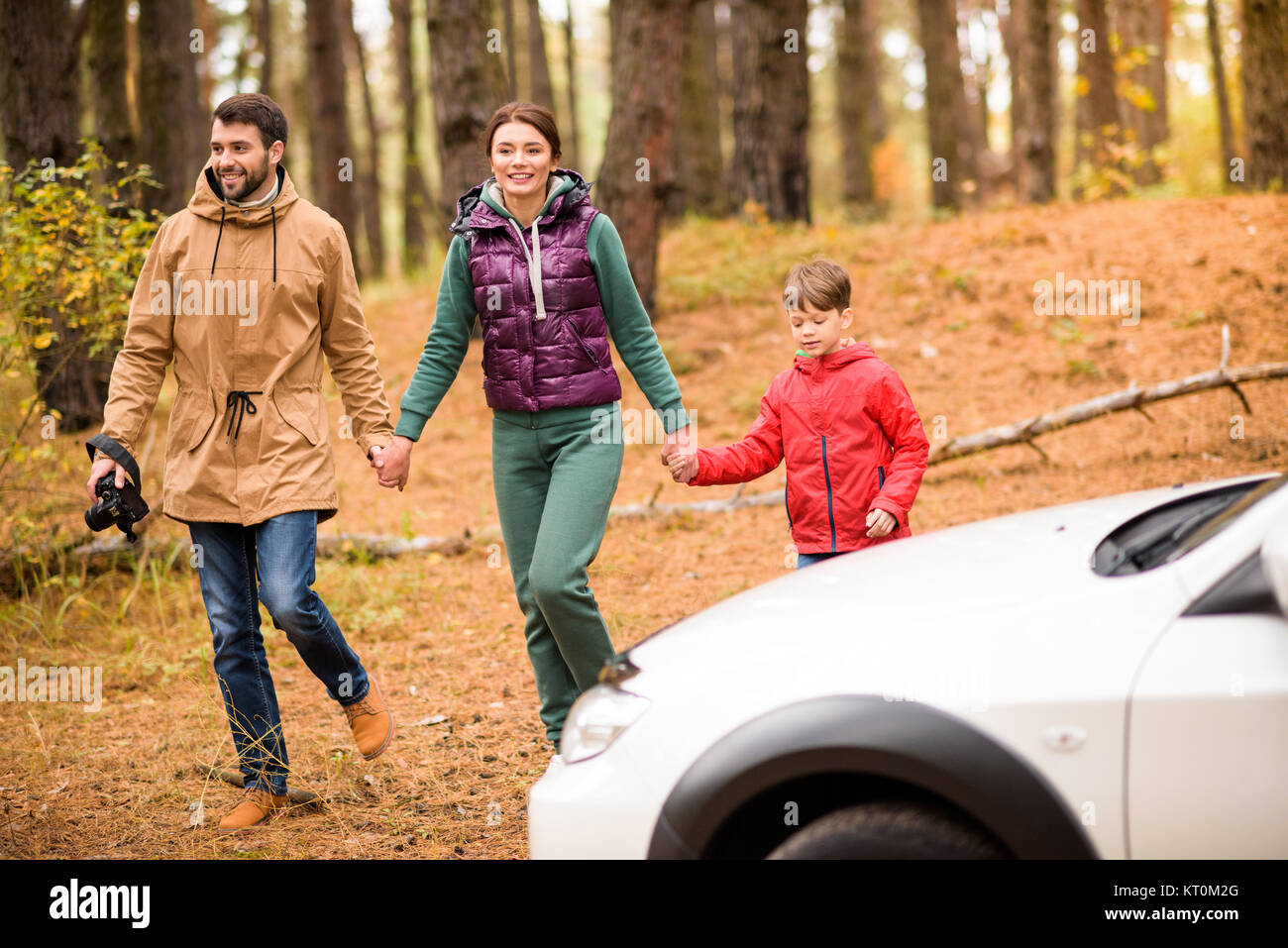 Family walking in autumn forest Stock Photo - Alamy