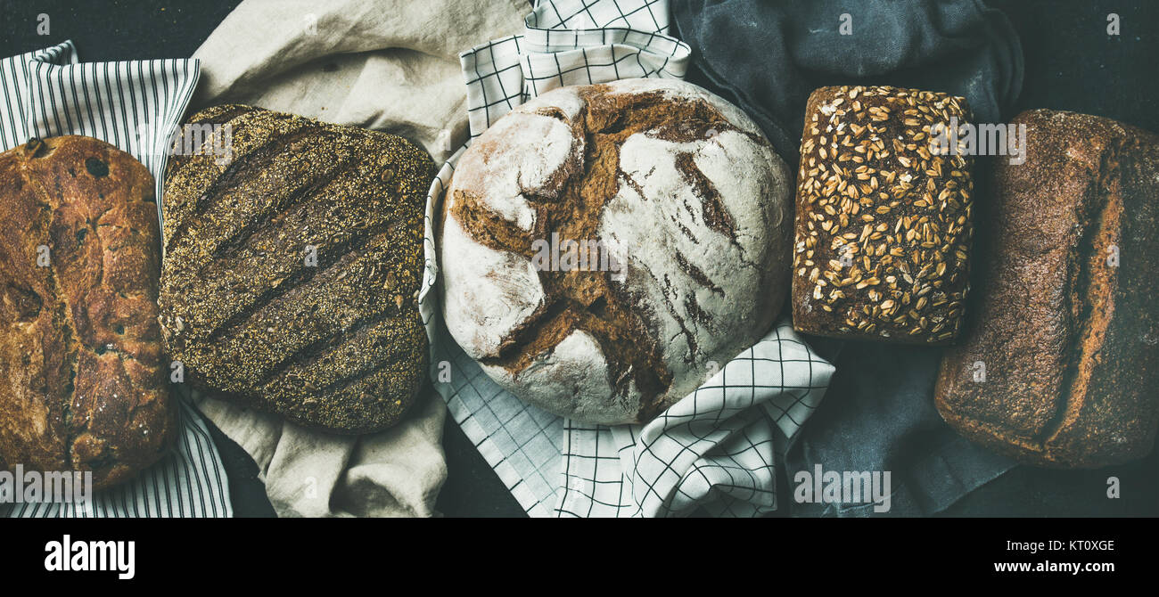 Various bread selection flatlay. Top view of Rye, wheat and multigrain rustic bread loaves over