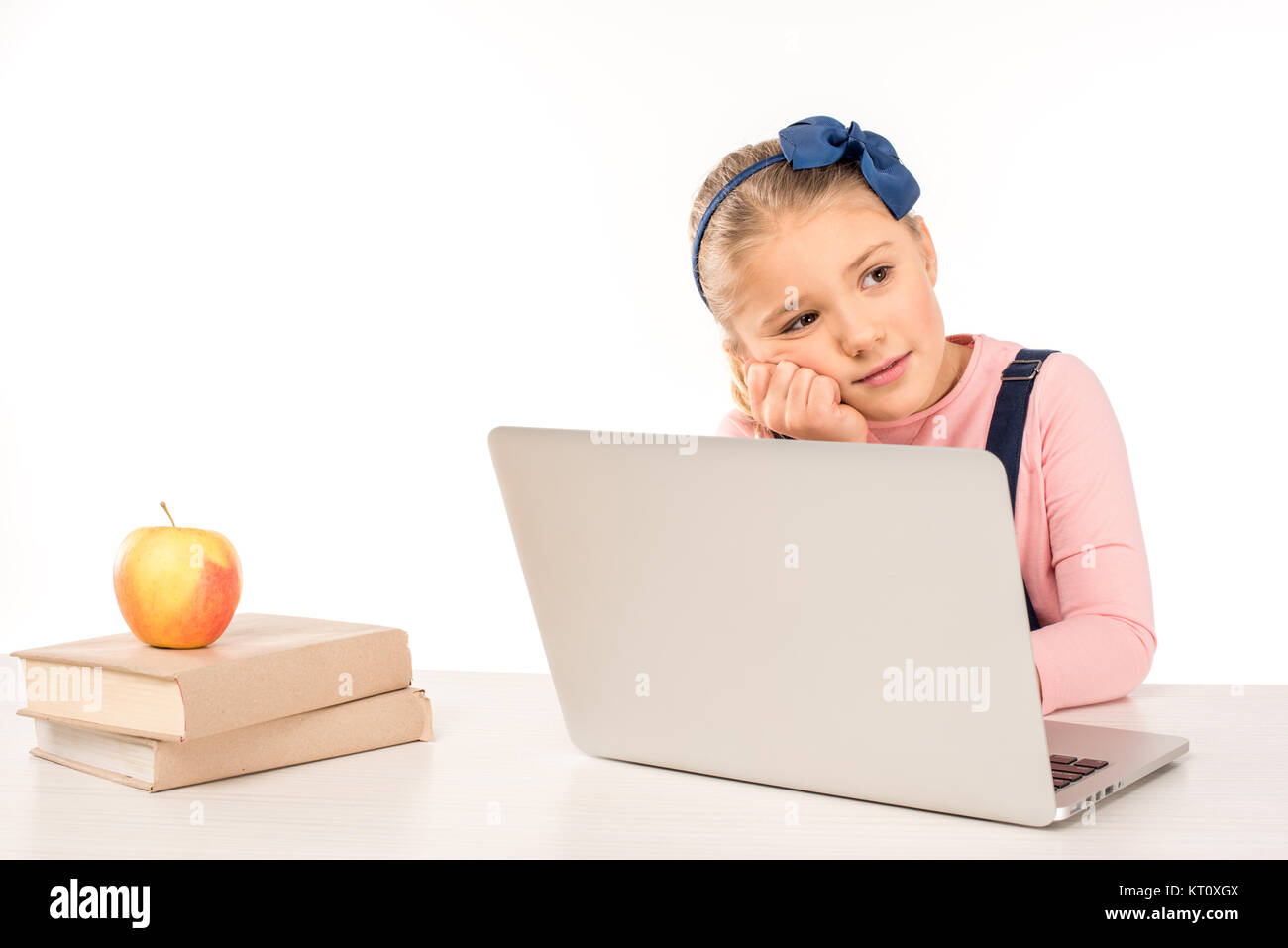 Schoolgirl at desk with laptop Stock Photo - Alamy