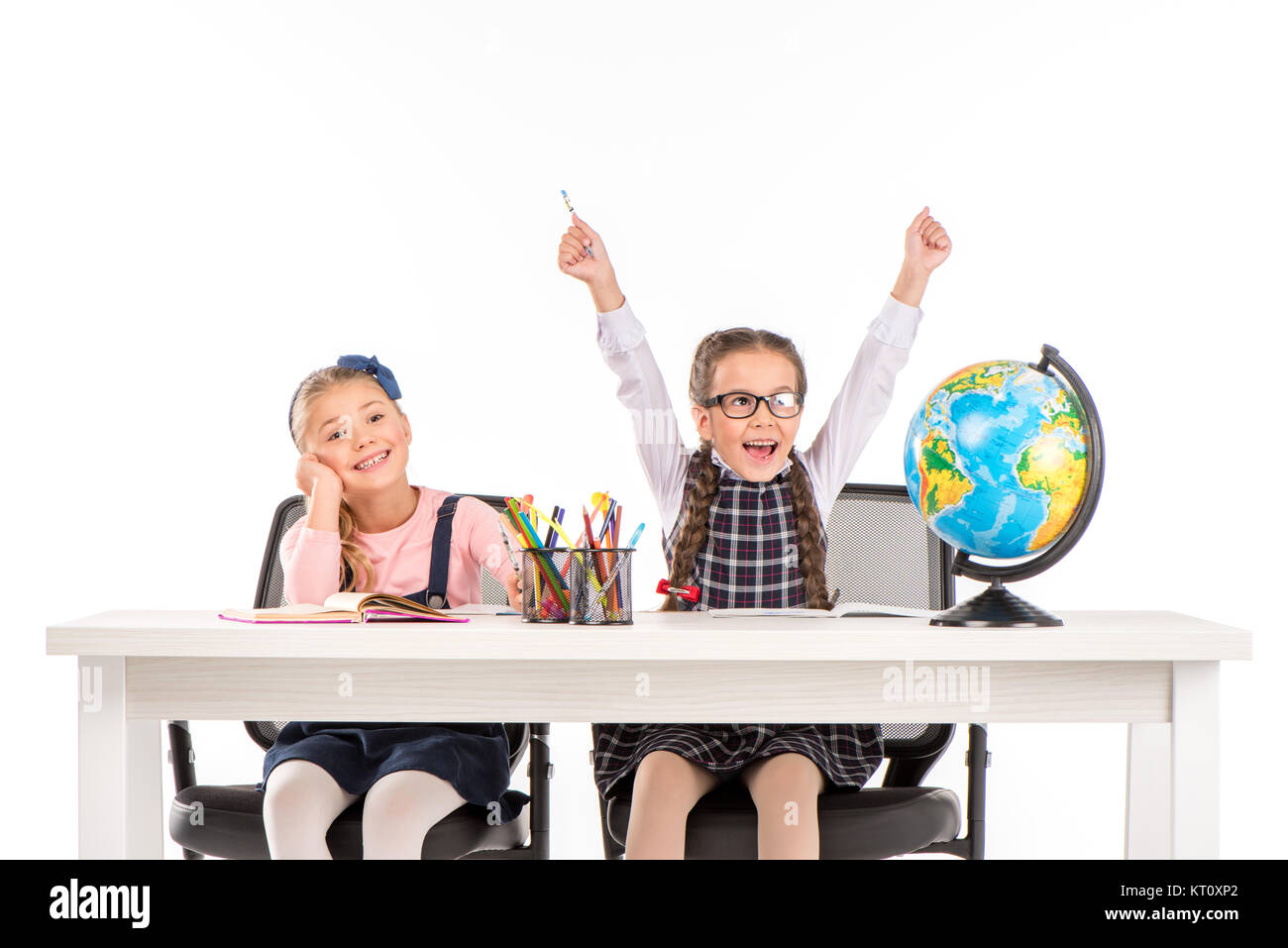 Happy schoolgirls sitting with globe Stock Photo - Alamy