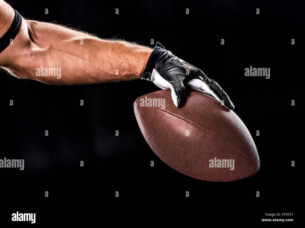 Football player holding ball Stock Photo - Alamy