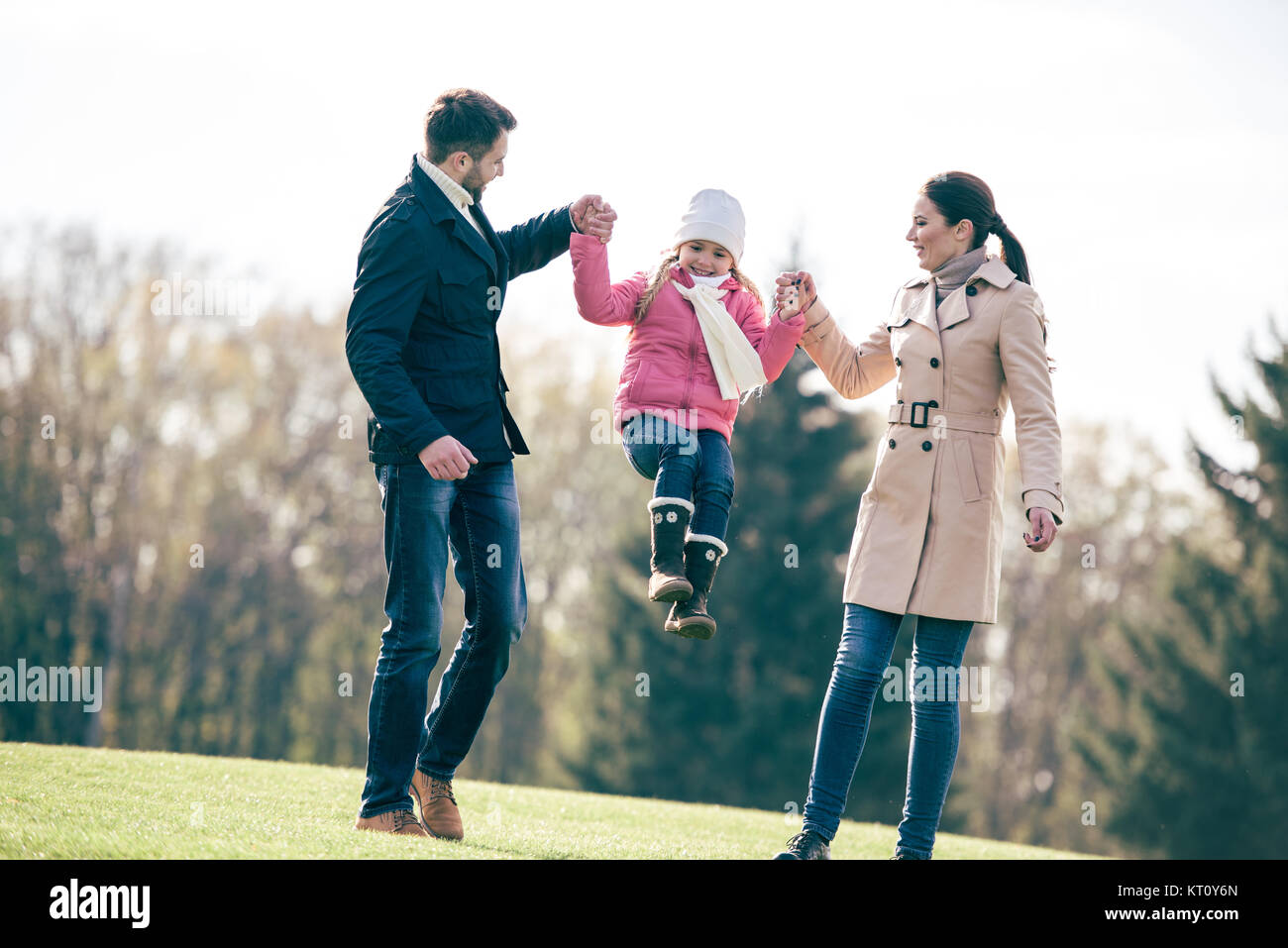 Happy family walking in park Stock Photo - Alamy