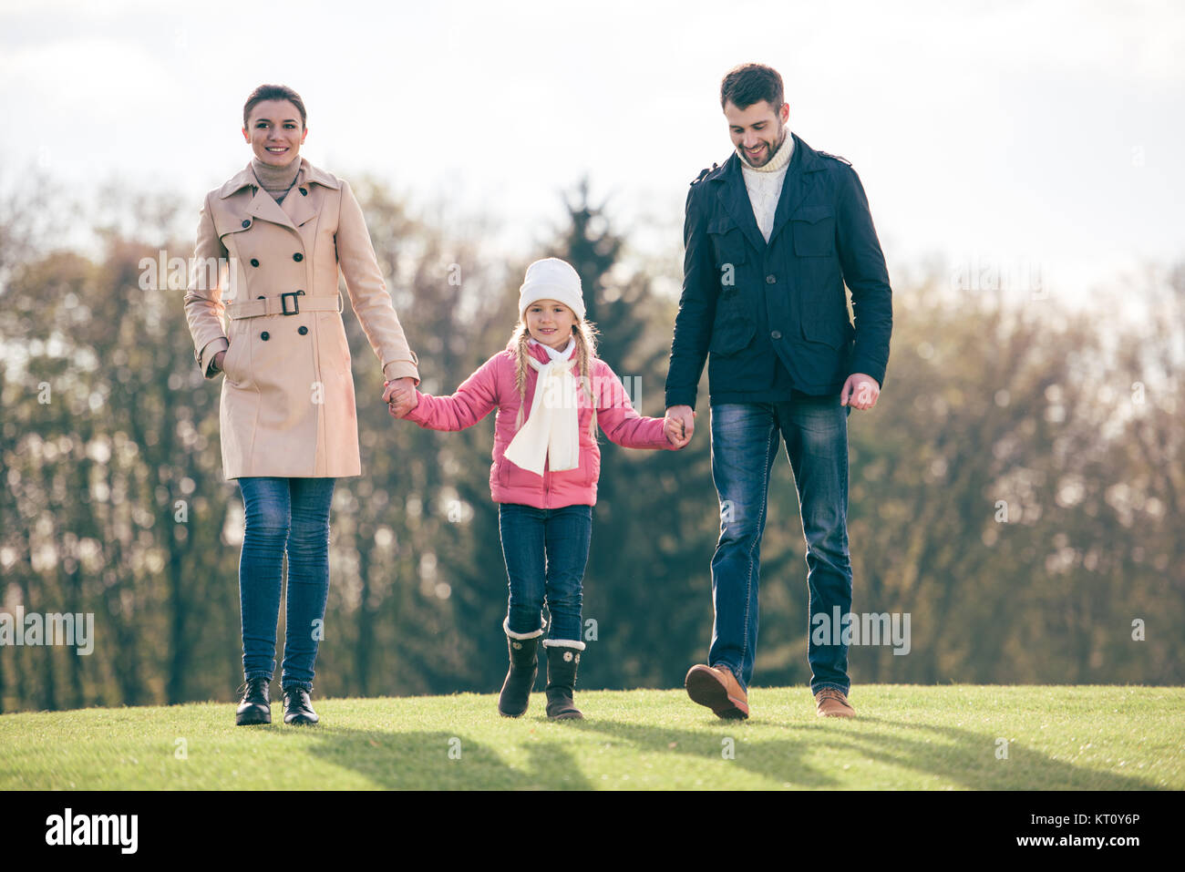 Happy family walking in park Stock Photo - Alamy