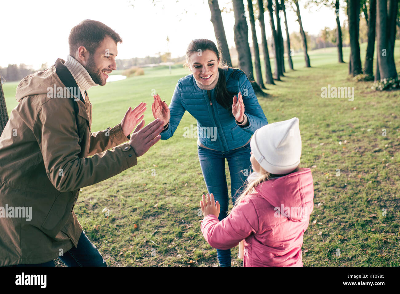 Happy family playing in park Stock Photo - Alamy