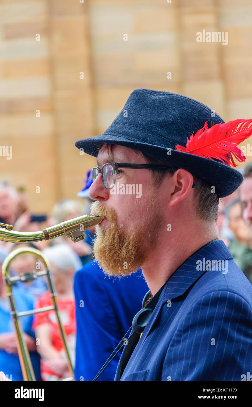 Male musician wearing a trilby hat with 
