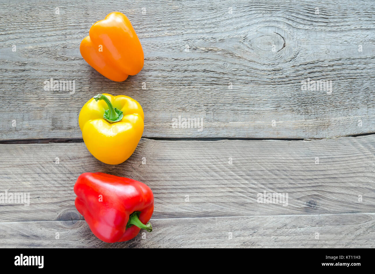 Bell peppers on the wooden background Stock Photo - Alamy