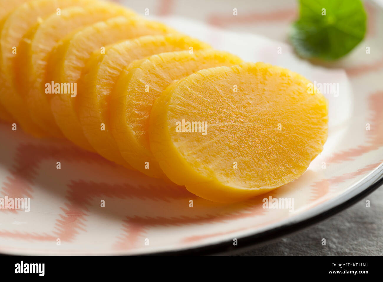 Traditional dish with sliced yellow Japanese pickled radish close up Stock Photo