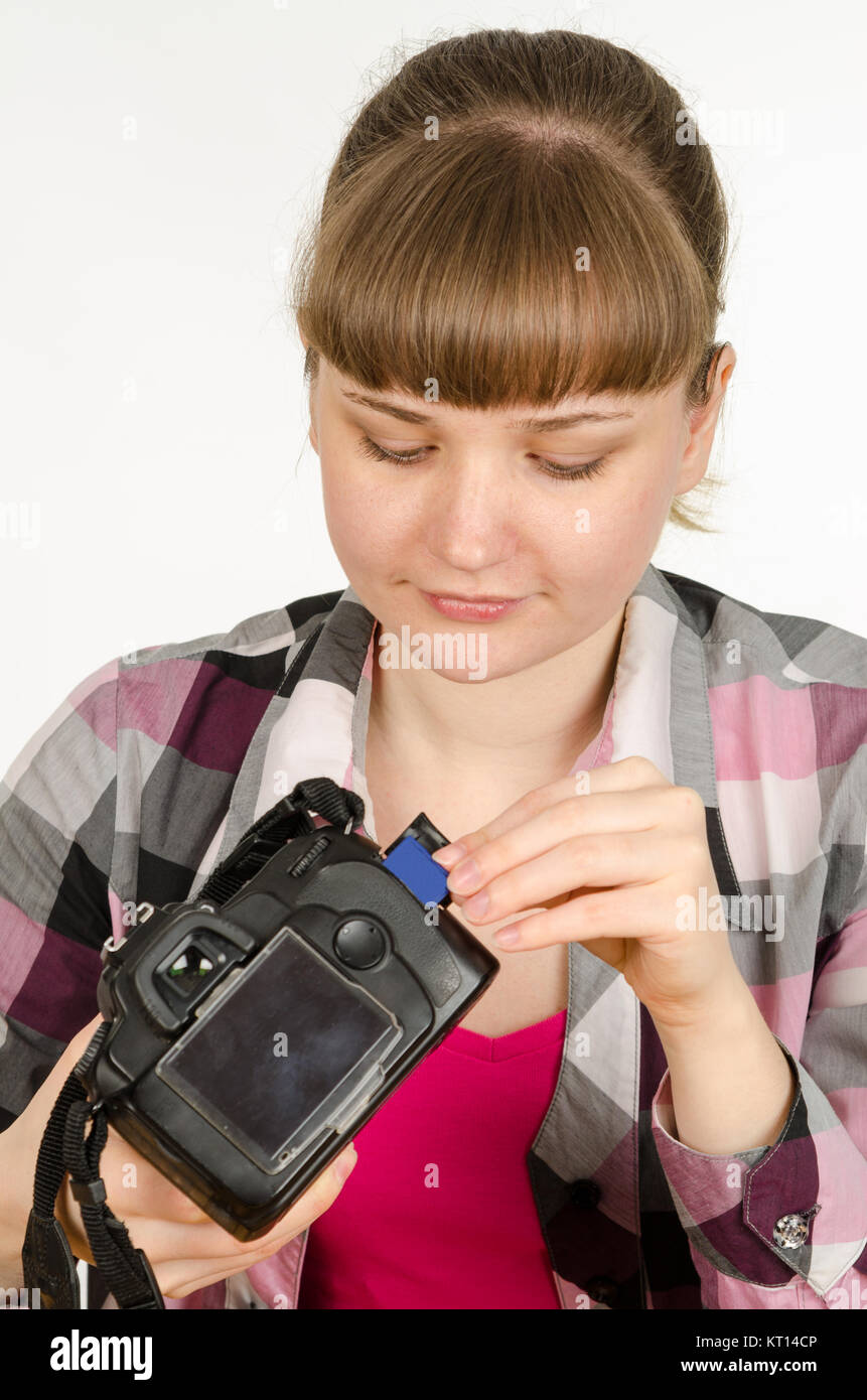 Photographer inserts a flash drive into the camera Stock Photo