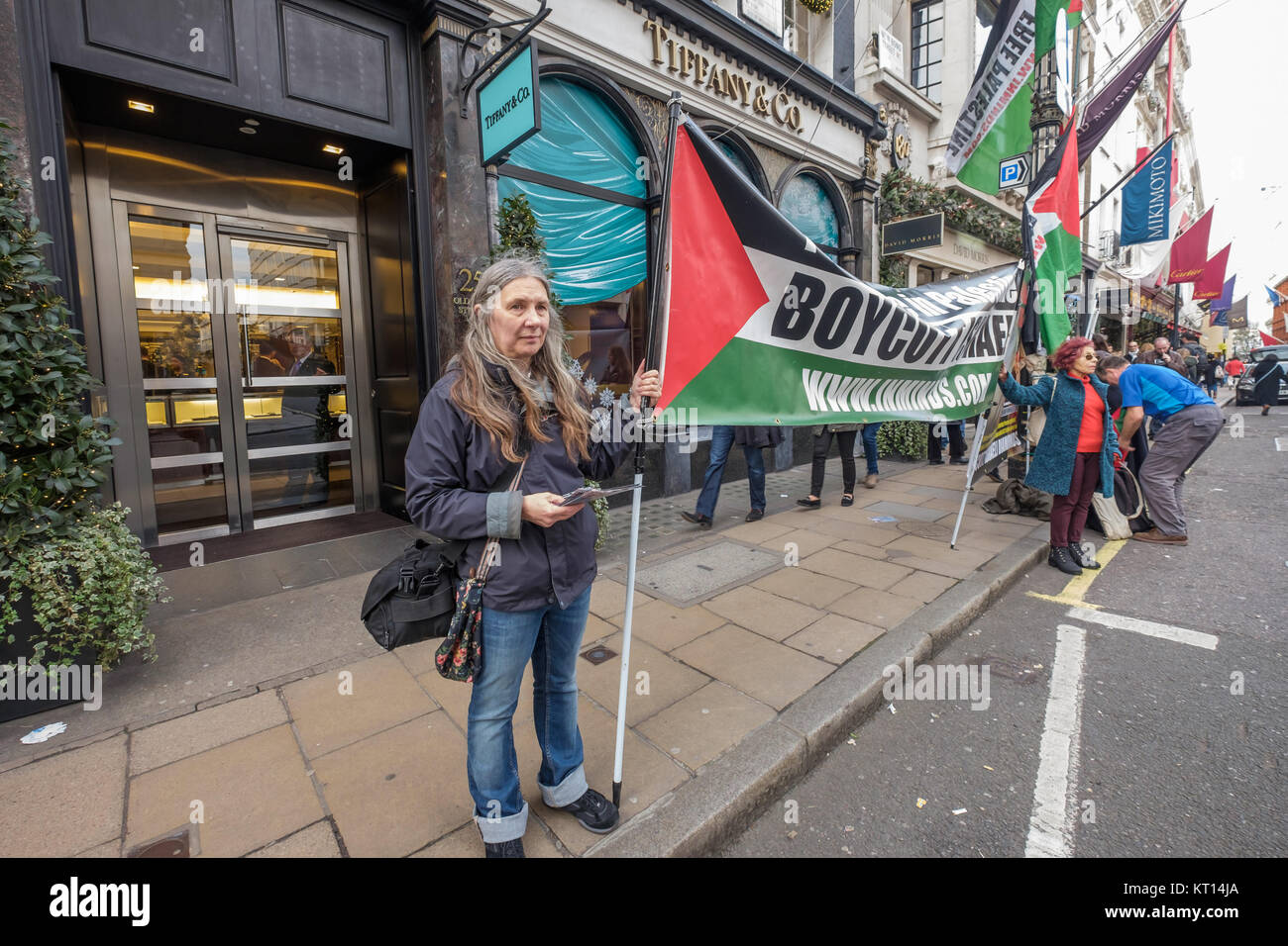 Protesters with banners outside Tiffany against selling 'Blood Diamonds' from the Steinmetz group which funded the Israeli Army's Givati Brigade, accused of war crimes. Stock Photo