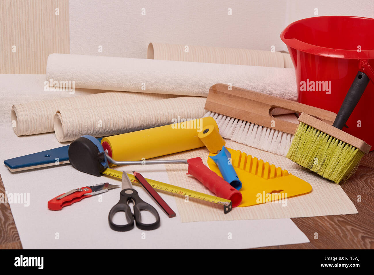 Rolls of wallpapers and various tools for wallpapering Stock Photo Alamy