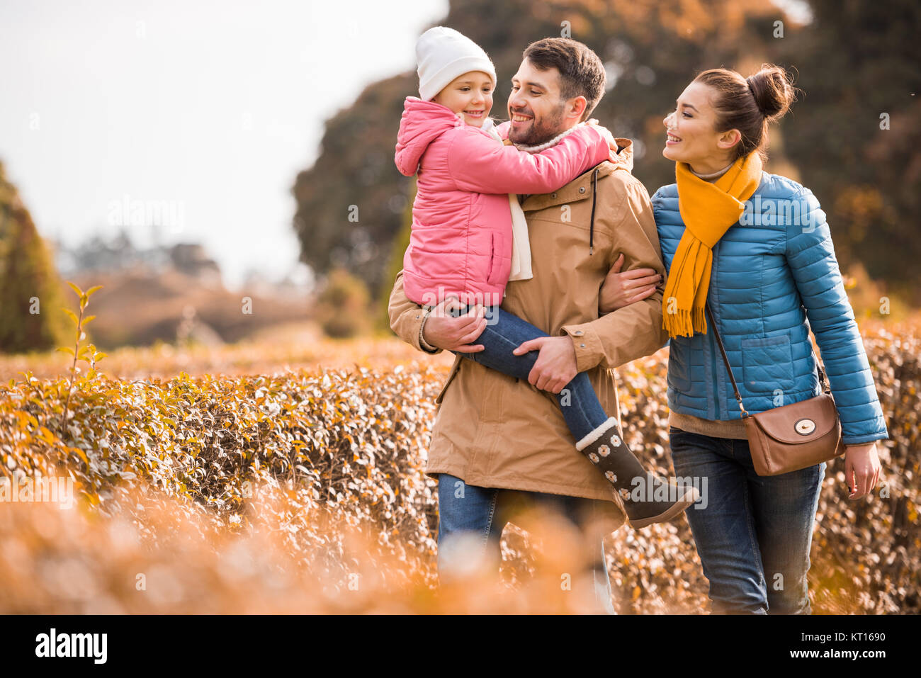 Happy family walking in park Stock Photo - Alamy