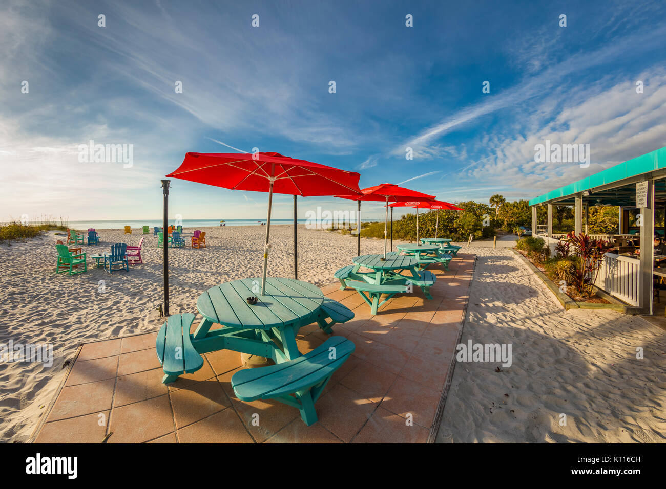 Picnic tables and chairs on the beach on a sunny day at the South Beach Bar & Grill on Gasparilla Island Florida Stock Photo