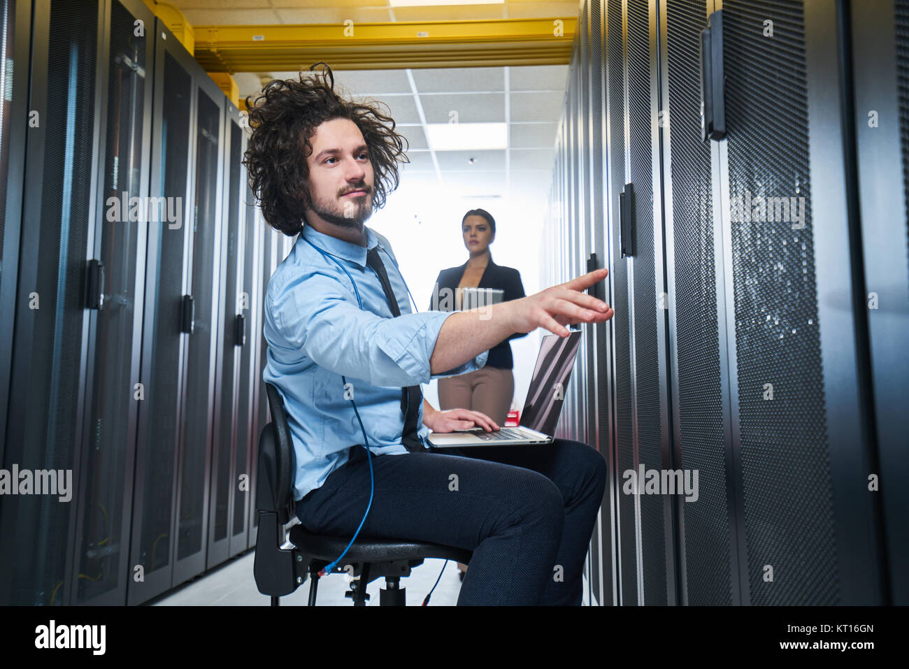 two young technicians working at a data center on server maintenance ...