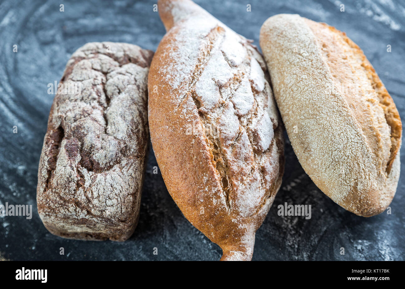 Whole grain breads on the dark wooden background Stock Photo - Alamy