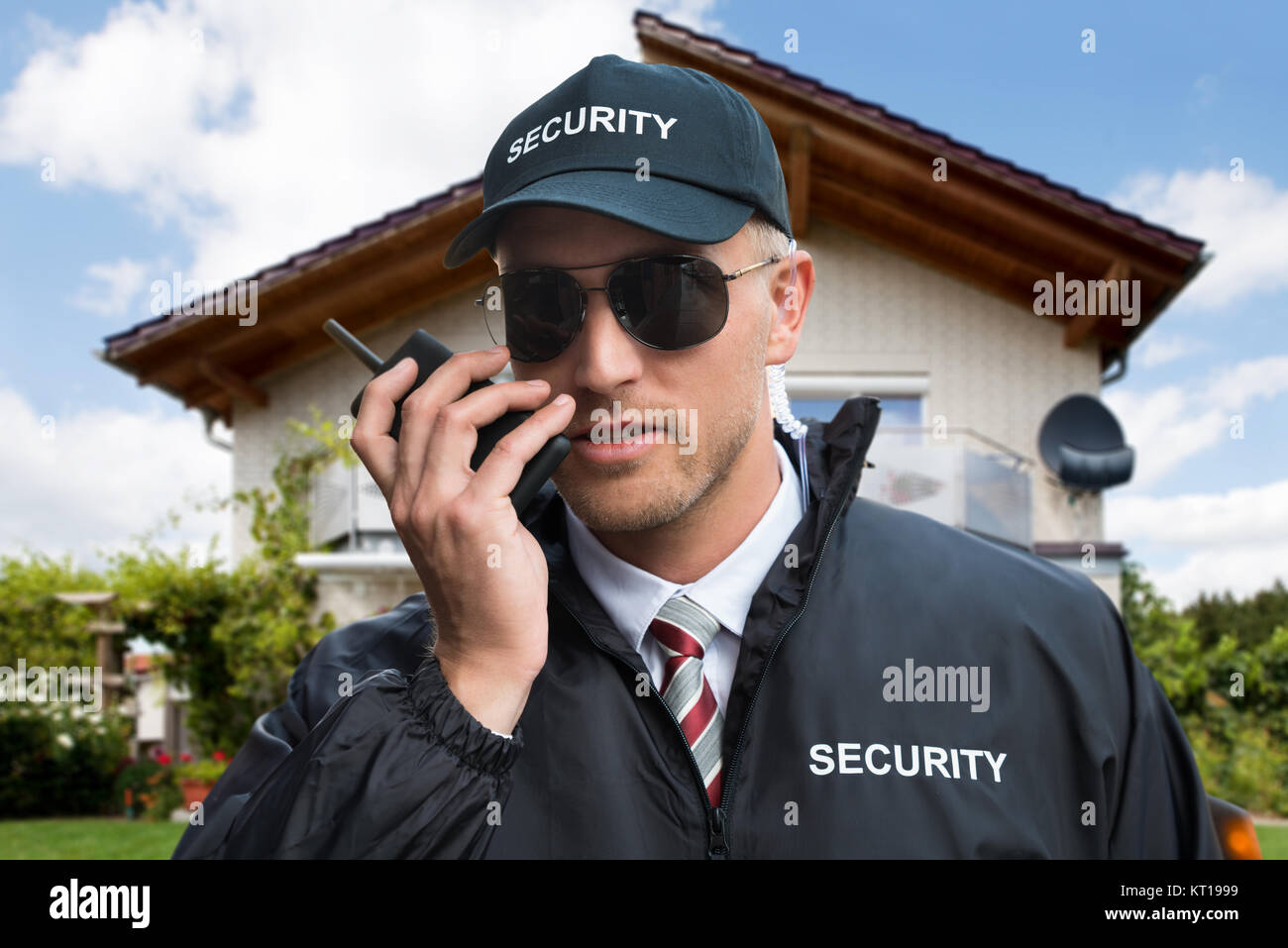 Male Security Guard Using Walkietalkie Stock Photo Alamy
