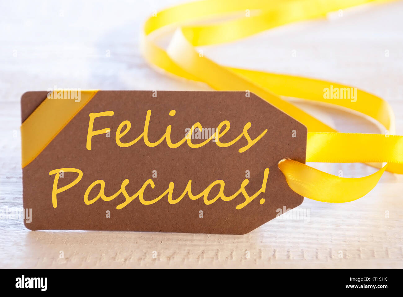 Label With Spanish Text Felices Pascuas Means Happy Easter. White Wooden Background. Card For Seasons Greetings Or Easter Greetings Stock Photo