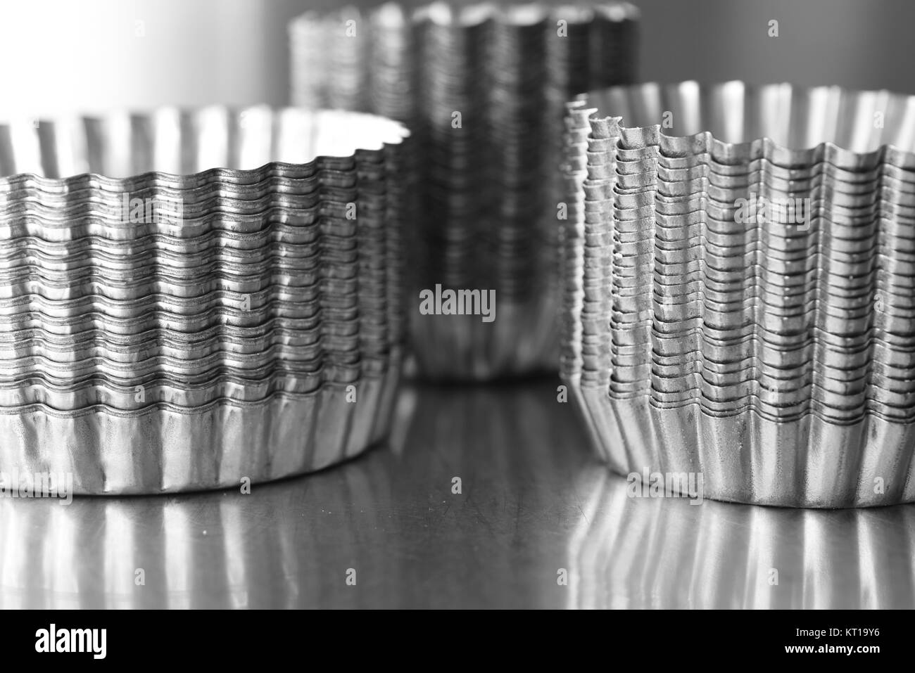 Stack of stainless steel pastry moulds Stock Photo