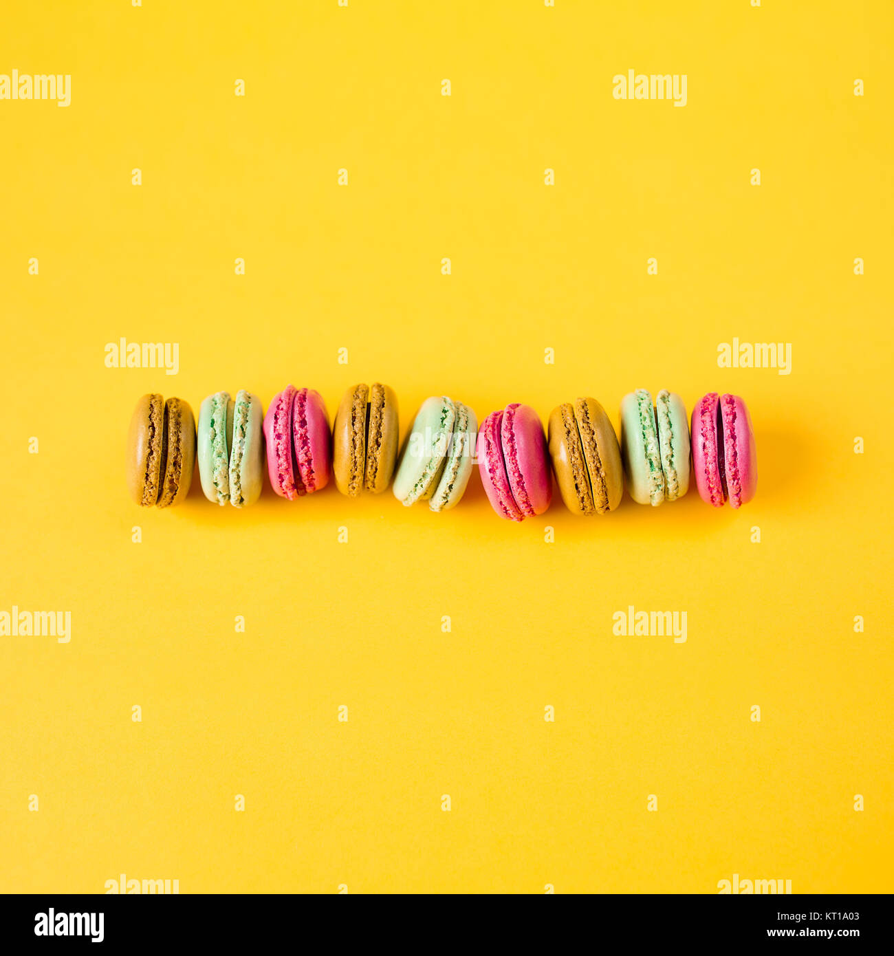 colorful macarons on yellow background Stock Photo