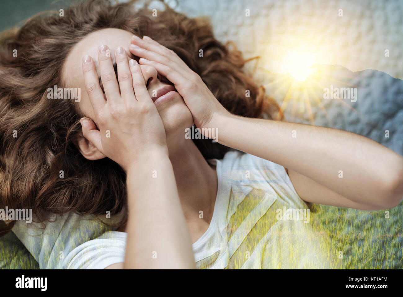 Tired woman putting hands on her face Stock Photo