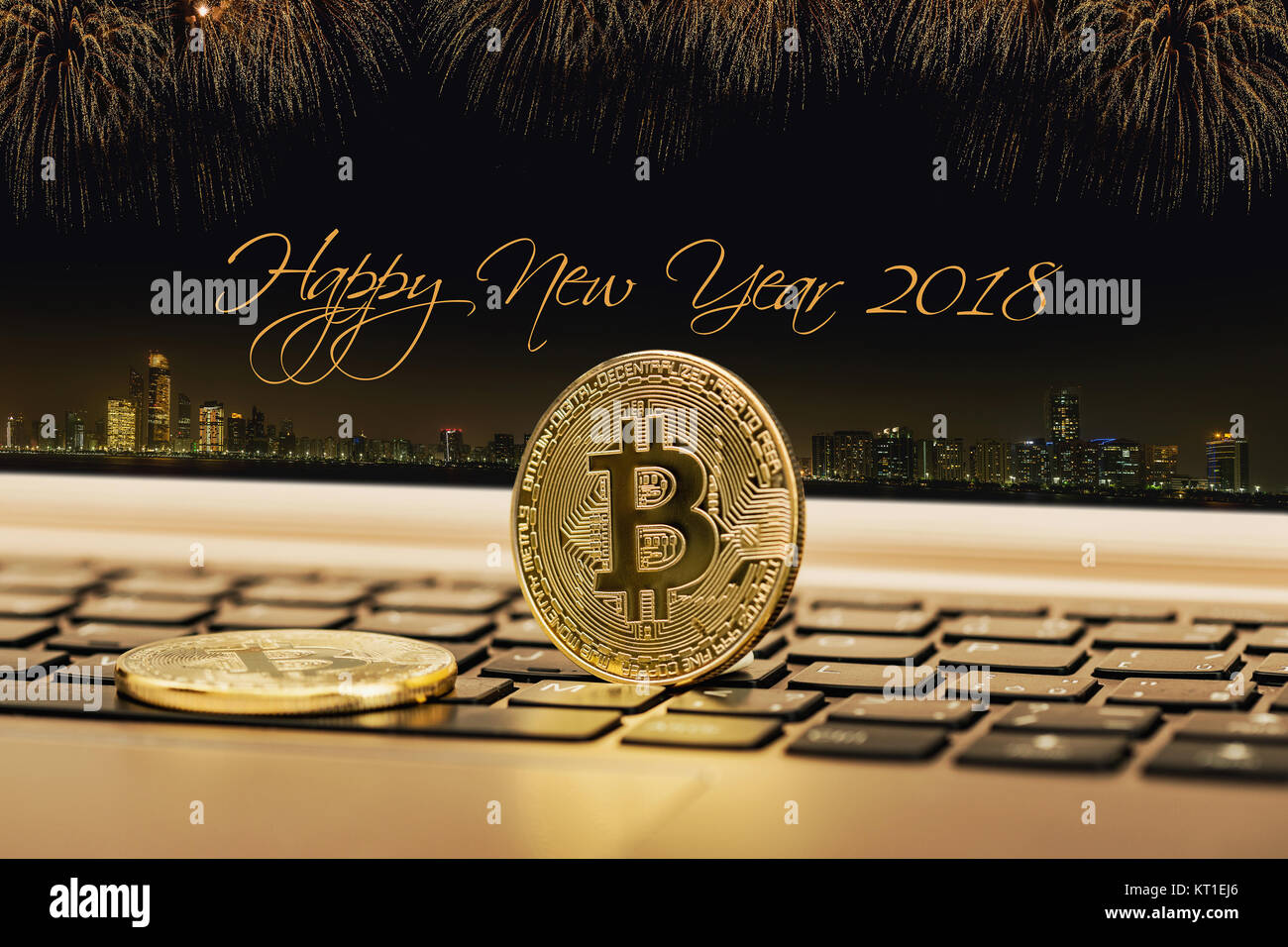 Happy new year 2018 with fireworks background. Celebration New Year 2018, Golden bitcoin coin on the black laptop keyboard. Macro. Stock Photo