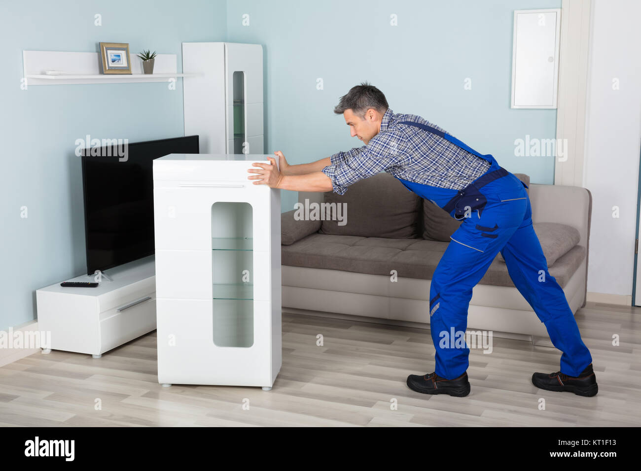 Mover Placing Furniture At Home Stock Photo Alamy
