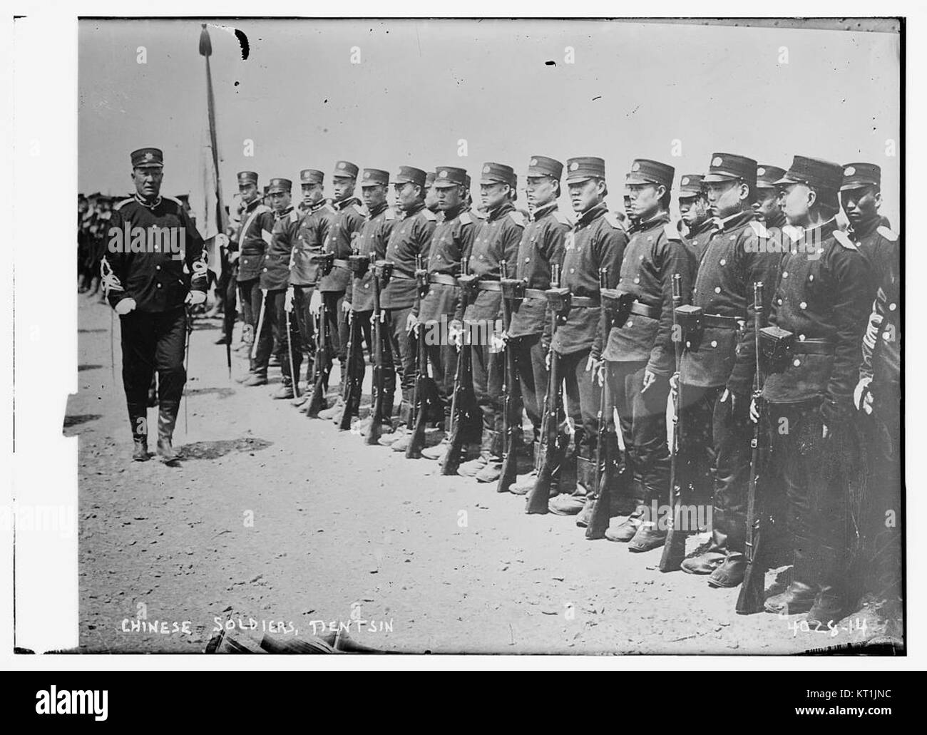 A group of Chinese soldiers in Tientsin, showcasing the military attire and structure during the late 19th century, possibly the Qing Dynasty period. Stock Photo