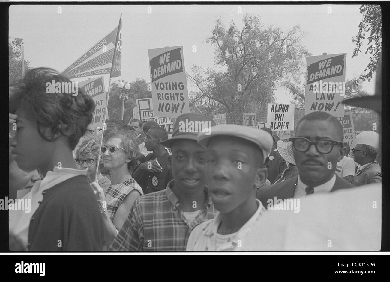 This photograph captures demonstrators holding signs during the ...
