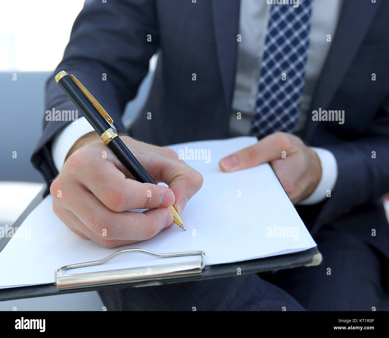Businessman signs a contract. Holding pen in hand Stock Photo - Alamy