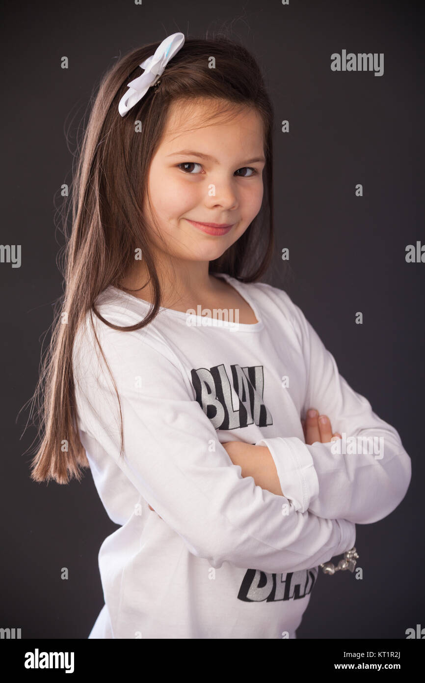 Portrait of a seven year old girl with long hair taken indoors. Stock Photo