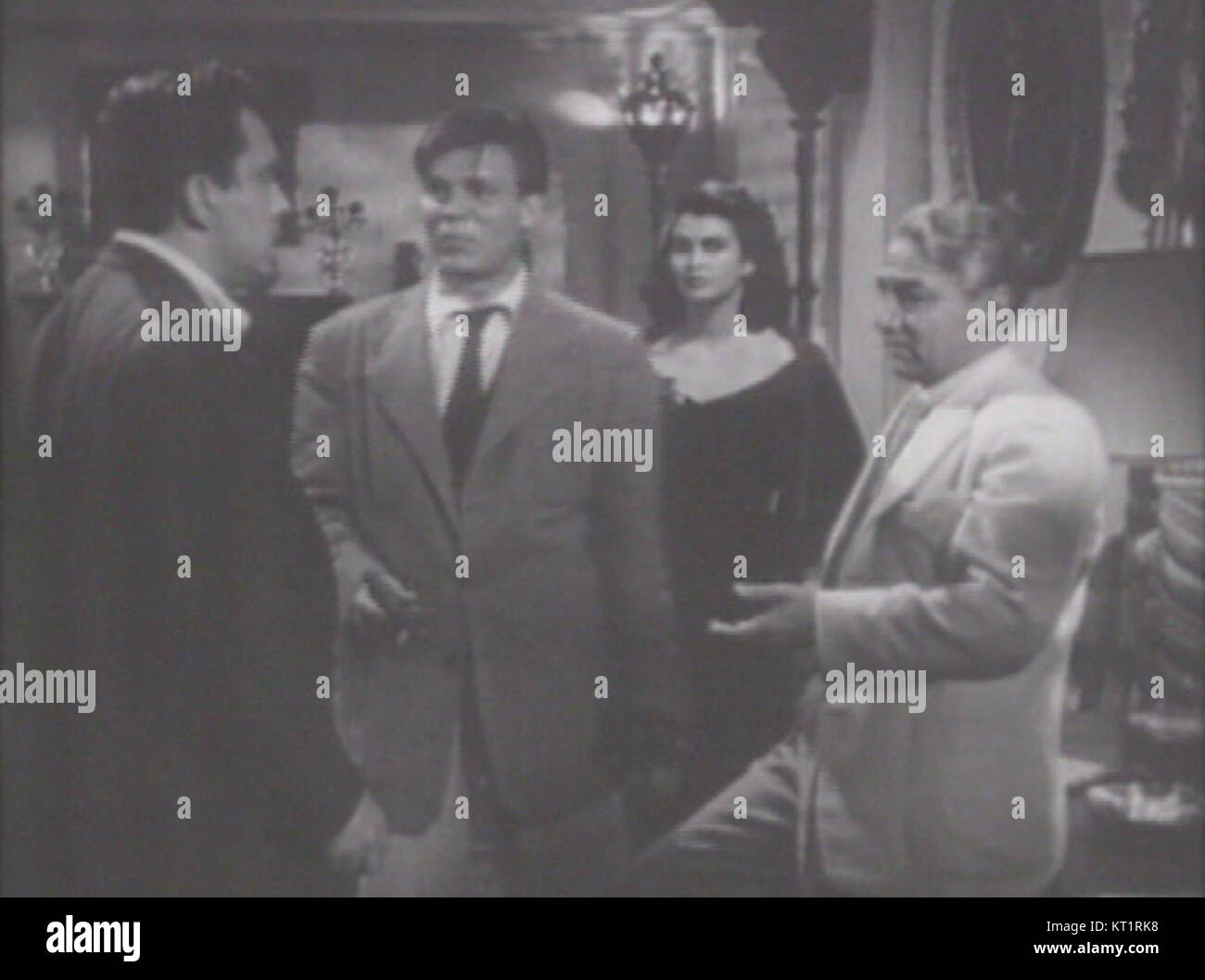 This still from the classic film *DOA* features Edmond O'Brien, Neville Brand, Laurette Luez, and Luther Adler, showcasing a pivotal scene in this 1950s crime thriller. Stock Photo