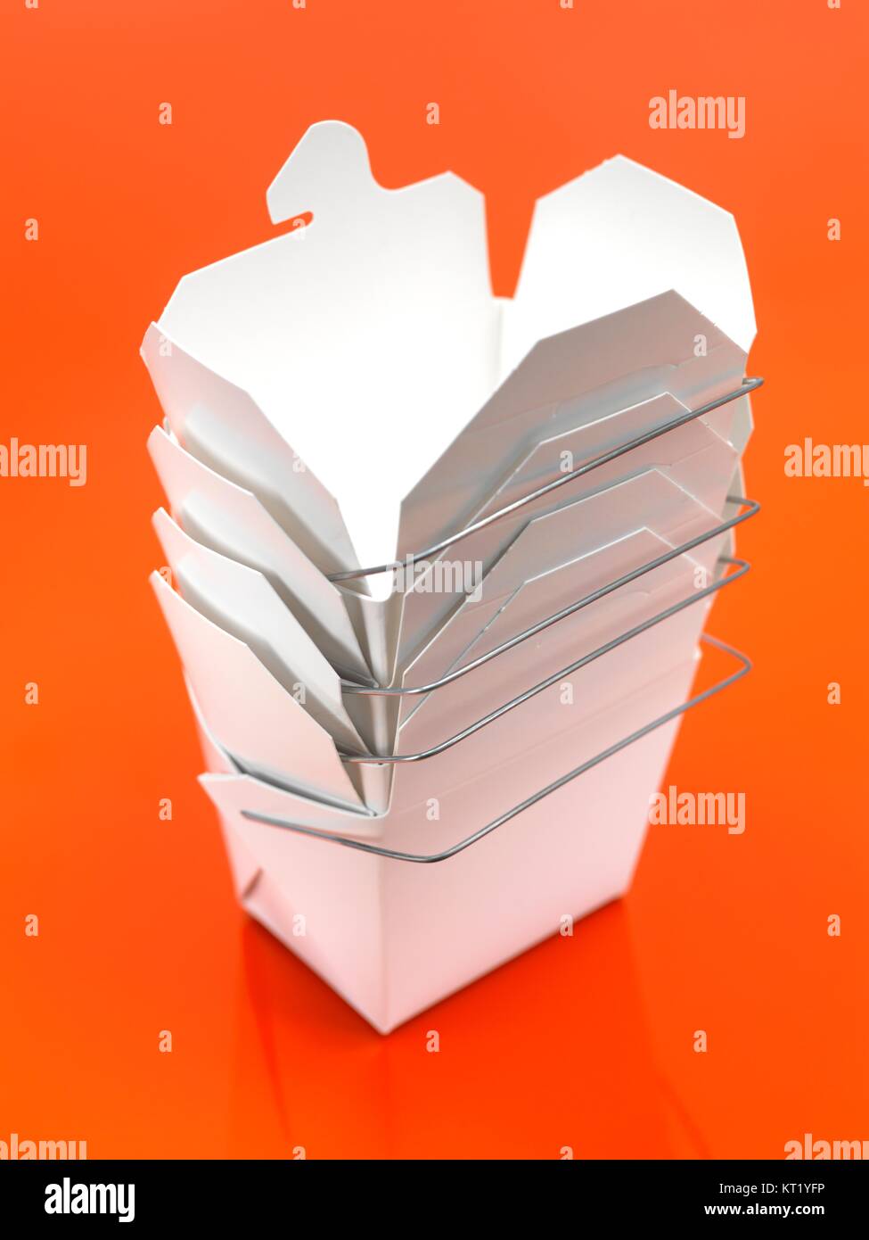 A Chinese takeaway container isolated against an orange background Stock Photo