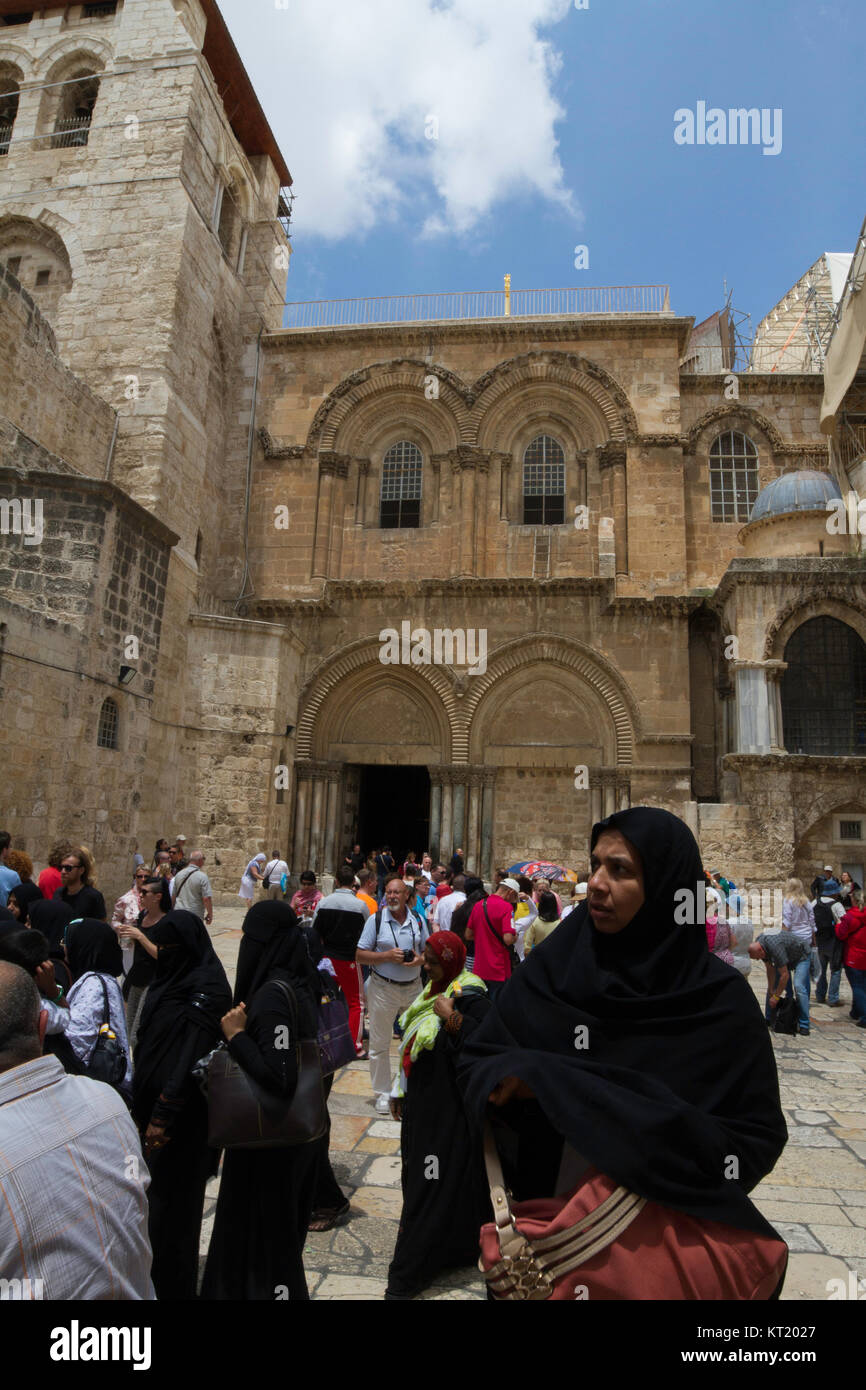 A muslim tourist stands in front of the Church of the Holy Sepulchre, Old City, Jerusalem. Stock Photo