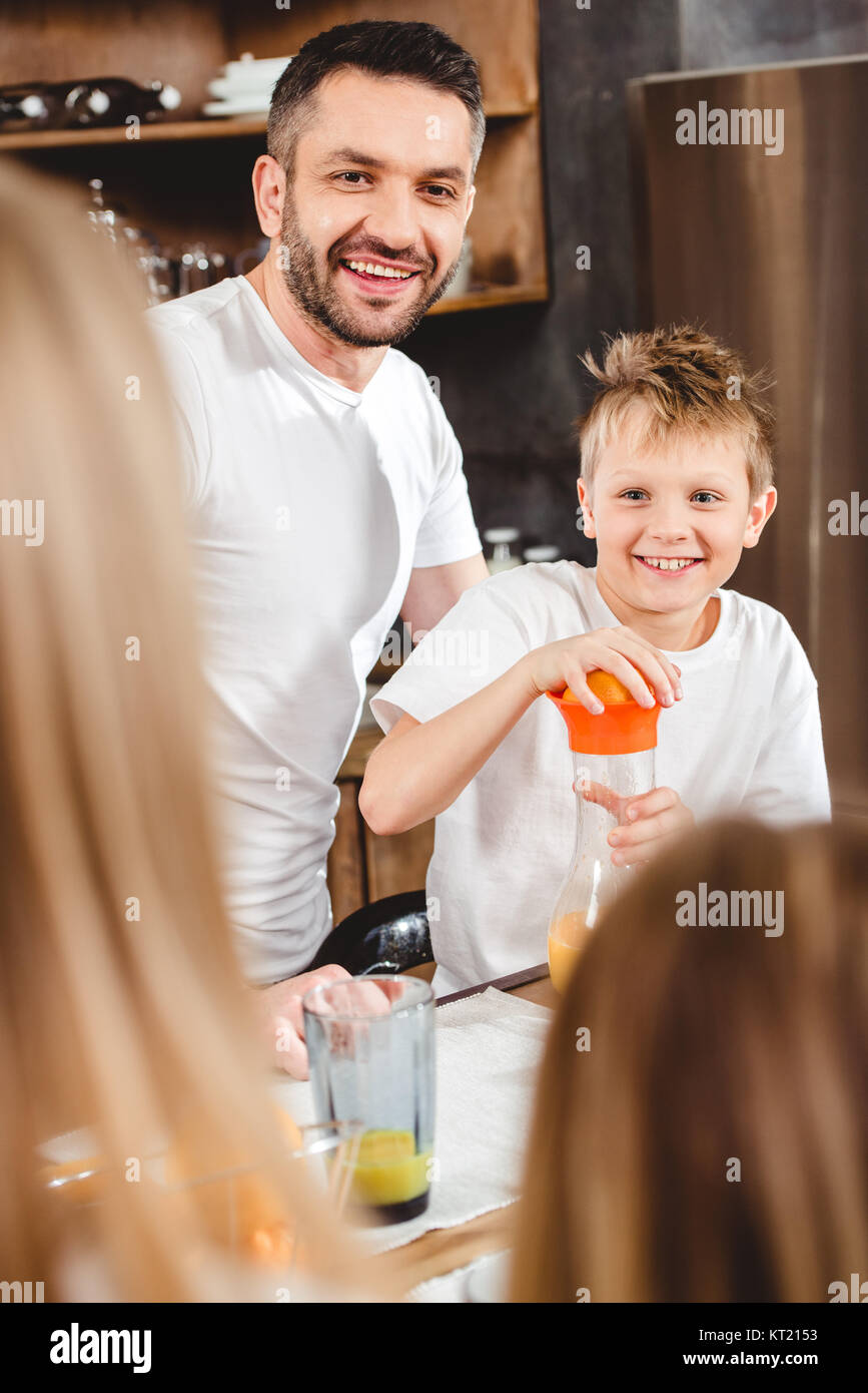 Little boy makes orange juice Stock Photo