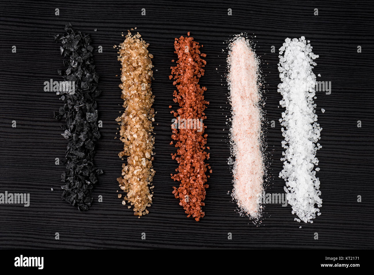 variety of natural and spicy salt on black table Stock Photo - Alamy