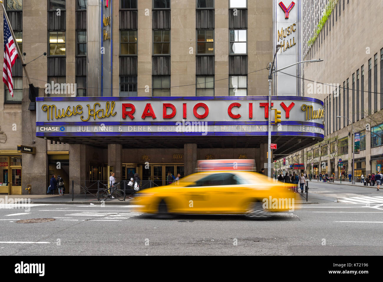 A yellow cab drives past the Radio City Music Hall building on 6th Avenue  in Manhattan, New York, USA Stock Photo - Alamy