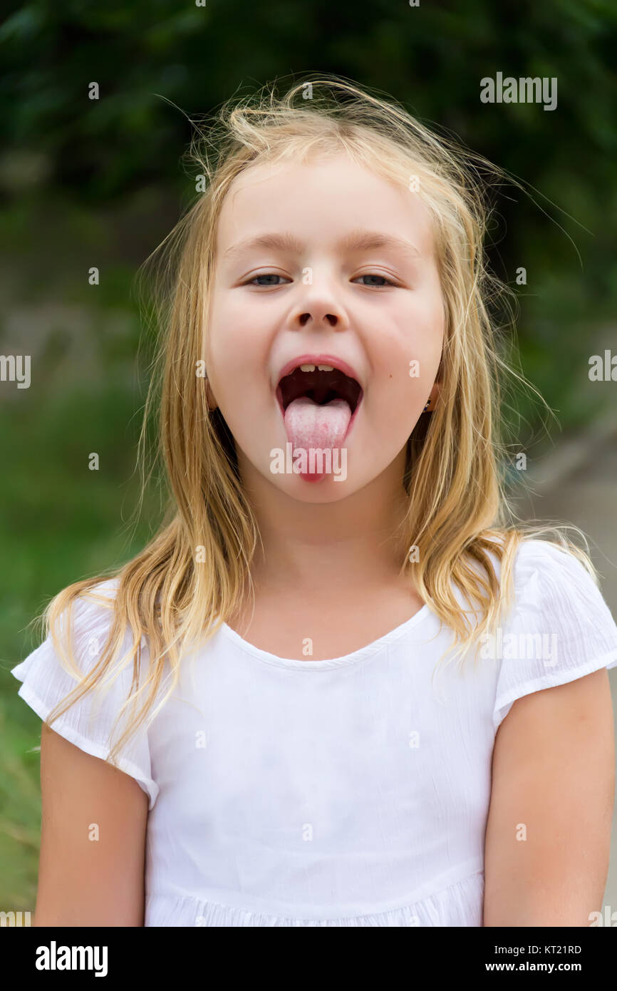 Cute girl with put out tongue Stock Photo