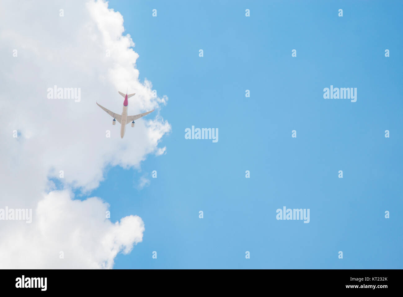 Plane flying and cloudy sky. Stock Photo